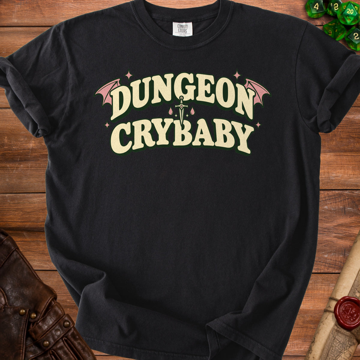 Black t-shirt with "Dungeon Crybaby" text, sword, and bat wings graphic.