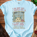 Light blue t-shirt with fluffy cat looking out window, saying "I just care about them from a great distance forever."