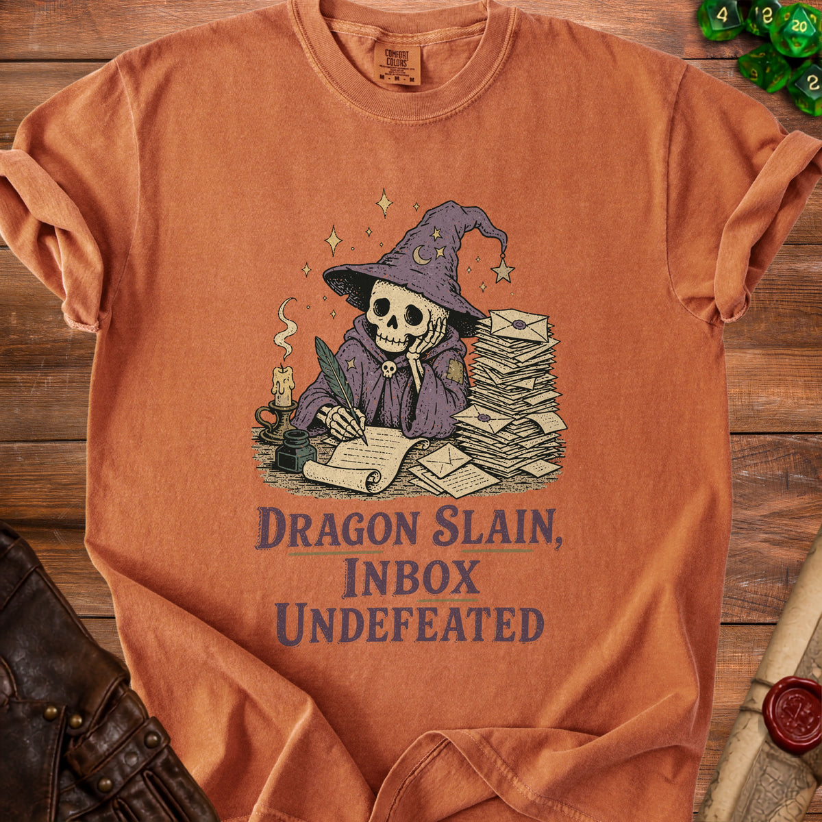 Skeleton wizard writing with feather pen, text "Dragon Slain, Inbox Undefeated."