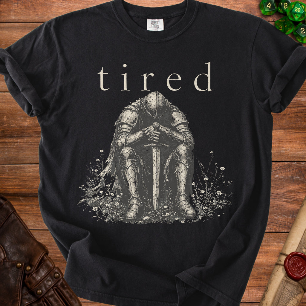 Black t-shirt with "tired" text above a seated knight holding a sword.