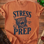Orange t-shirt with distressed graphic of a screaming cat, a d20 die, and text: "STRESS COUNTS AS PREP".