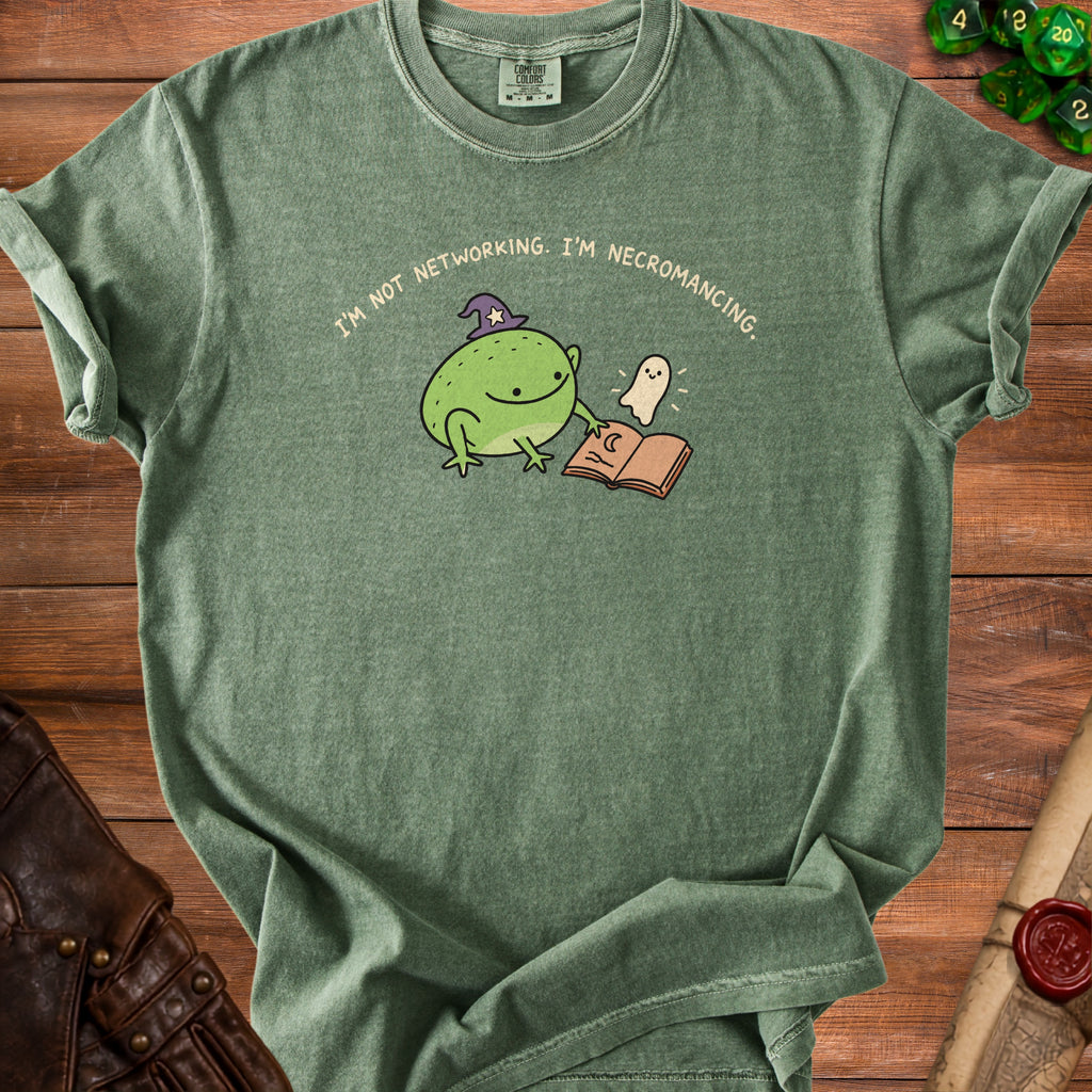 Green t-shirt with frog, ghost, and book graphic reading "I'm not networking. I'm necromancing."
