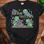 Three mint green cats in adventurer gear open a treasure chest with dice and books.