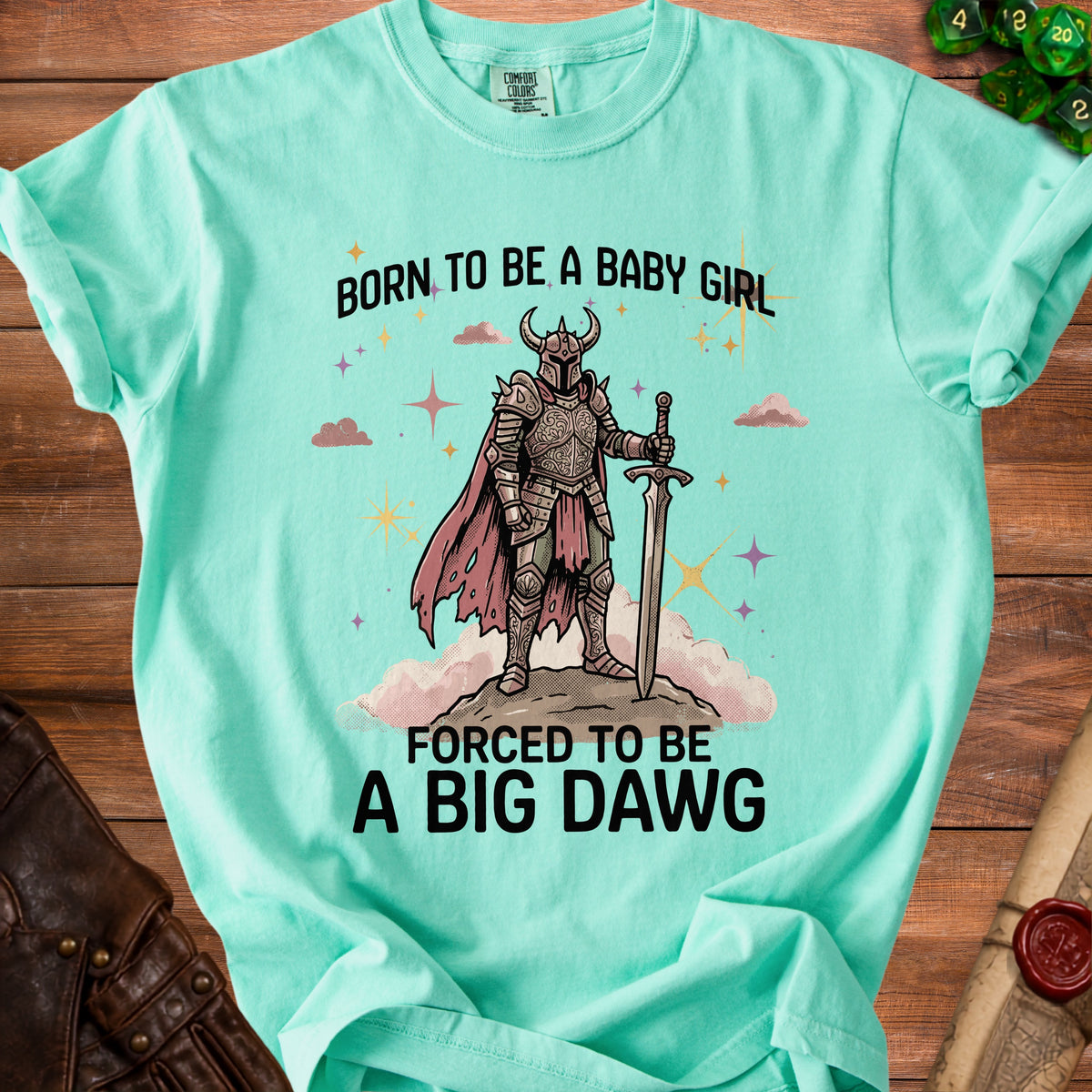 Teal t-shirt with knight illustration and text "Born to be a baby girl, forced to be a big dawg."