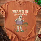 Mummy folding laundry with text "WRAPPED UP in chores".