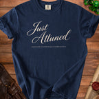 Navy t-shirt with "Just Attuned" and "emotionally attached to questionable artifacts" text.
