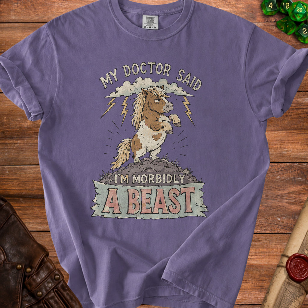 Purple t-shirt with illustration of a pony, clouds, lightning, and text "I'm Morbidly A Beast".