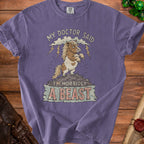 Purple t-shirt with illustration of a pony, clouds, lightning, and text "I'm Morbidly A Beast".