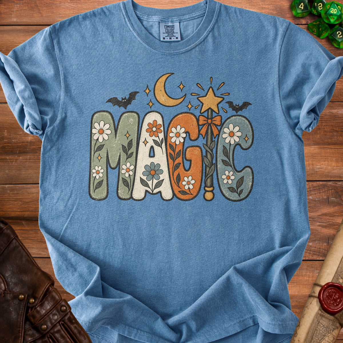 Blue t-shirt with "MAGIC" in retro letters, moon, star, and bats.