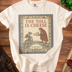 Cream t-shirt with illustration of a dragon and man on a bridge holding cheese. Text reads "The Toll is Cheese".