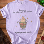 Purple t-shirt with text "Remember, the only magic that matters is your personal growth".