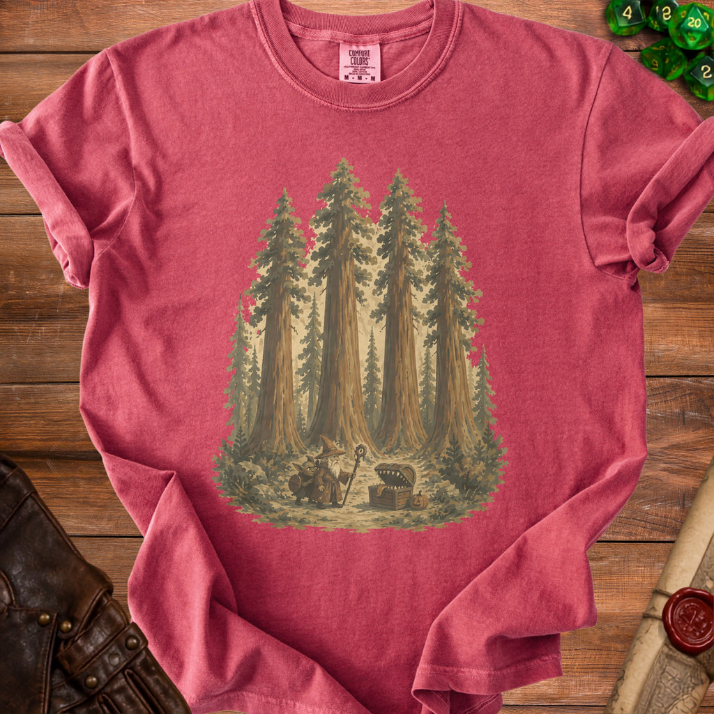 Red t-shirt with a graphic of a wizard, goblin, and treasure chest among tall trees.