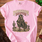 A pink t-shirt featuring a western-style illustration of a female adventurer with the text Dungeon Drifter.