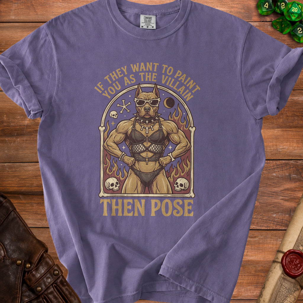 T-shirt graphic with muscular dog in sunglasses and BDSM-style outfit, text "If they want to paint you as the villain then pose".