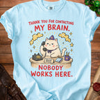 Light blue t-shirt with graphic: cat on phone, "MY BRAIN. NOBODY WORKS HERE."