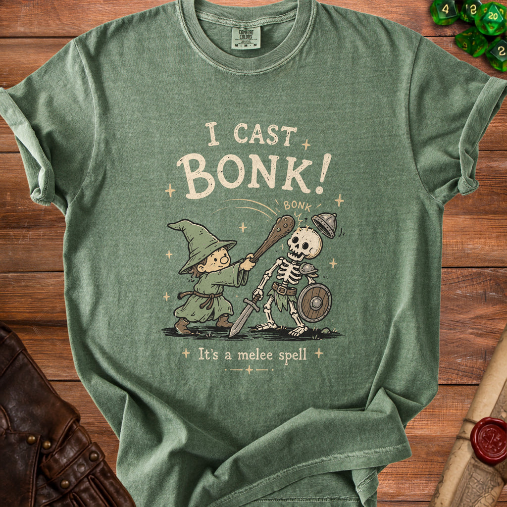 Green t-shirt with wizard casting "Bonk!" on a skeleton with text "It's a melee spell".