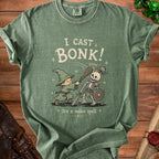 Green t-shirt with wizard casting "Bonk!" on a skeleton with text "It's a melee spell".