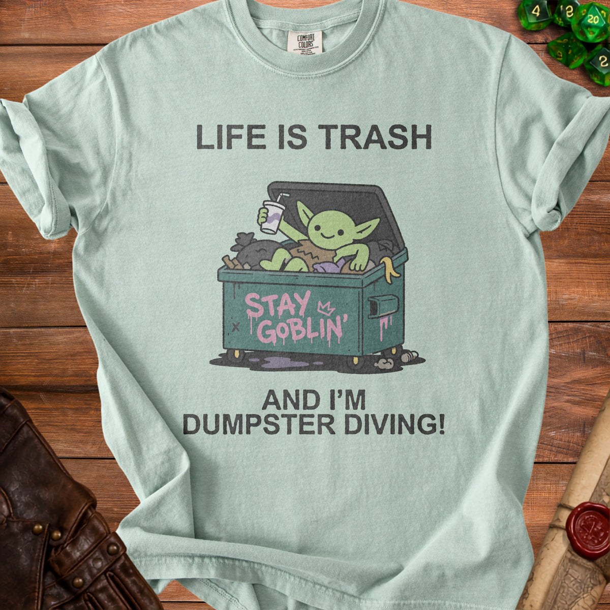 Light blue t-shirt with "Life is Trash" and a goblin in a dumpster.