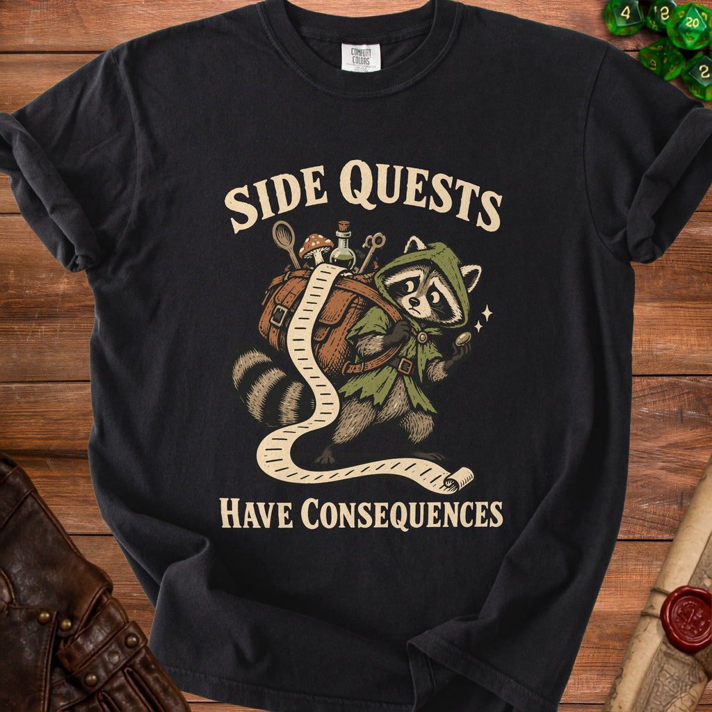 Black t-shirt with raccoon carrying a backpack and a long scroll with "SIDE QUESTS HAVE CONSEQUENCES".