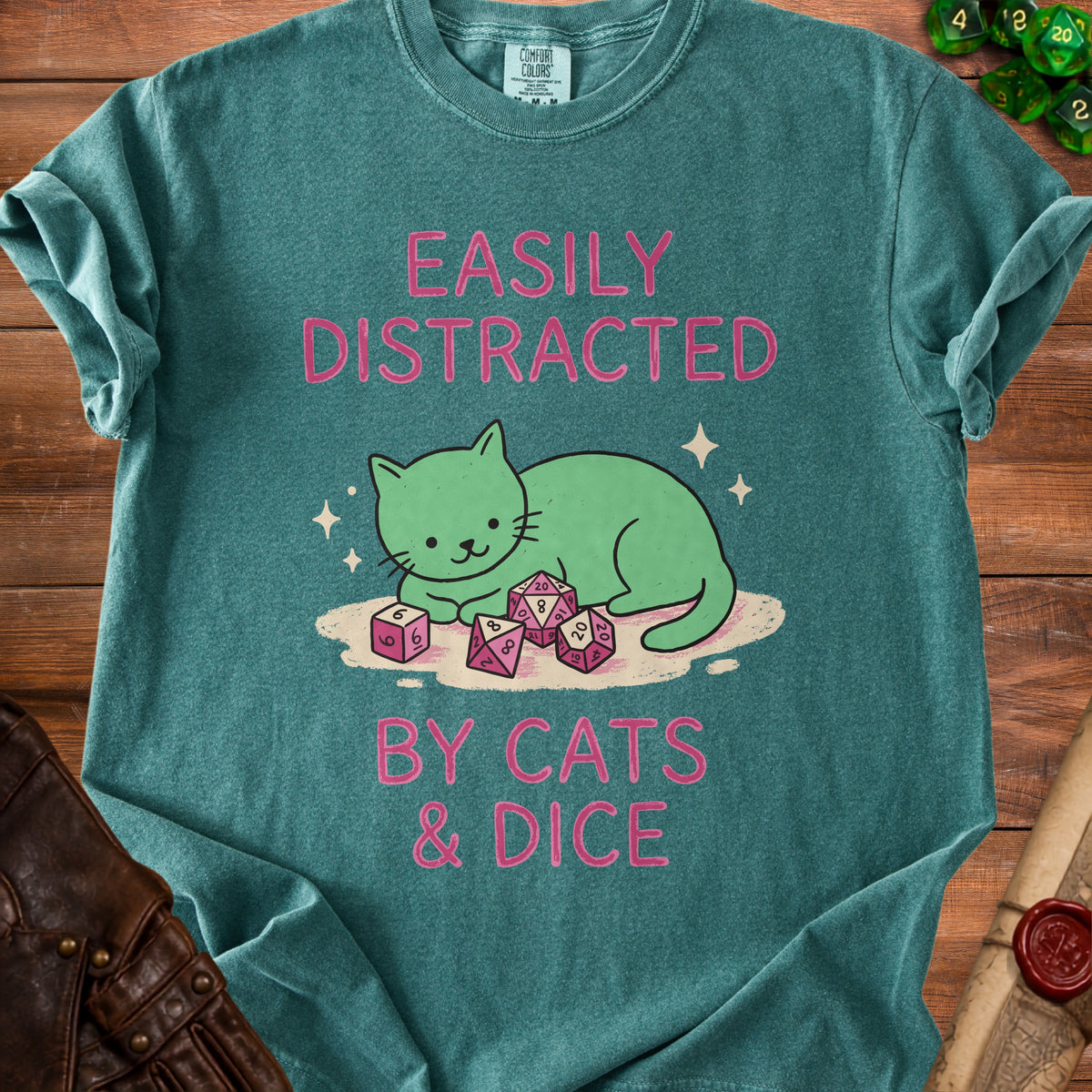 Teal t-shirt with "Easily Distracted By Cats & Dice" text and cartoon cat.