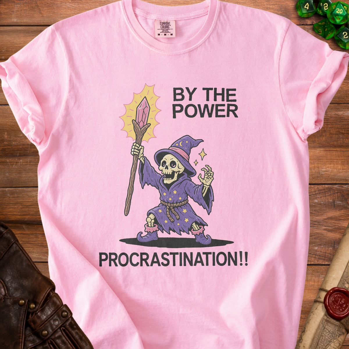 Pink t-shirt with skeleton wizard graphic and text "BY THE POWER PROCRASTINATION!!".