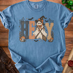 Blue t-shirt with a graphic of a ghost in a witch hat saying "HEY".