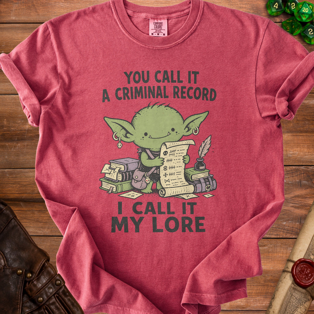 Crimson t-shirt with a green goblin character holding a scroll. Text reads "You Call It A Criminal Record, I Call It My Lore".