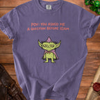 Purple t-shirt with green creature and text "POV: YOU ASKED ME A QUESTION BEFORE 10AM".