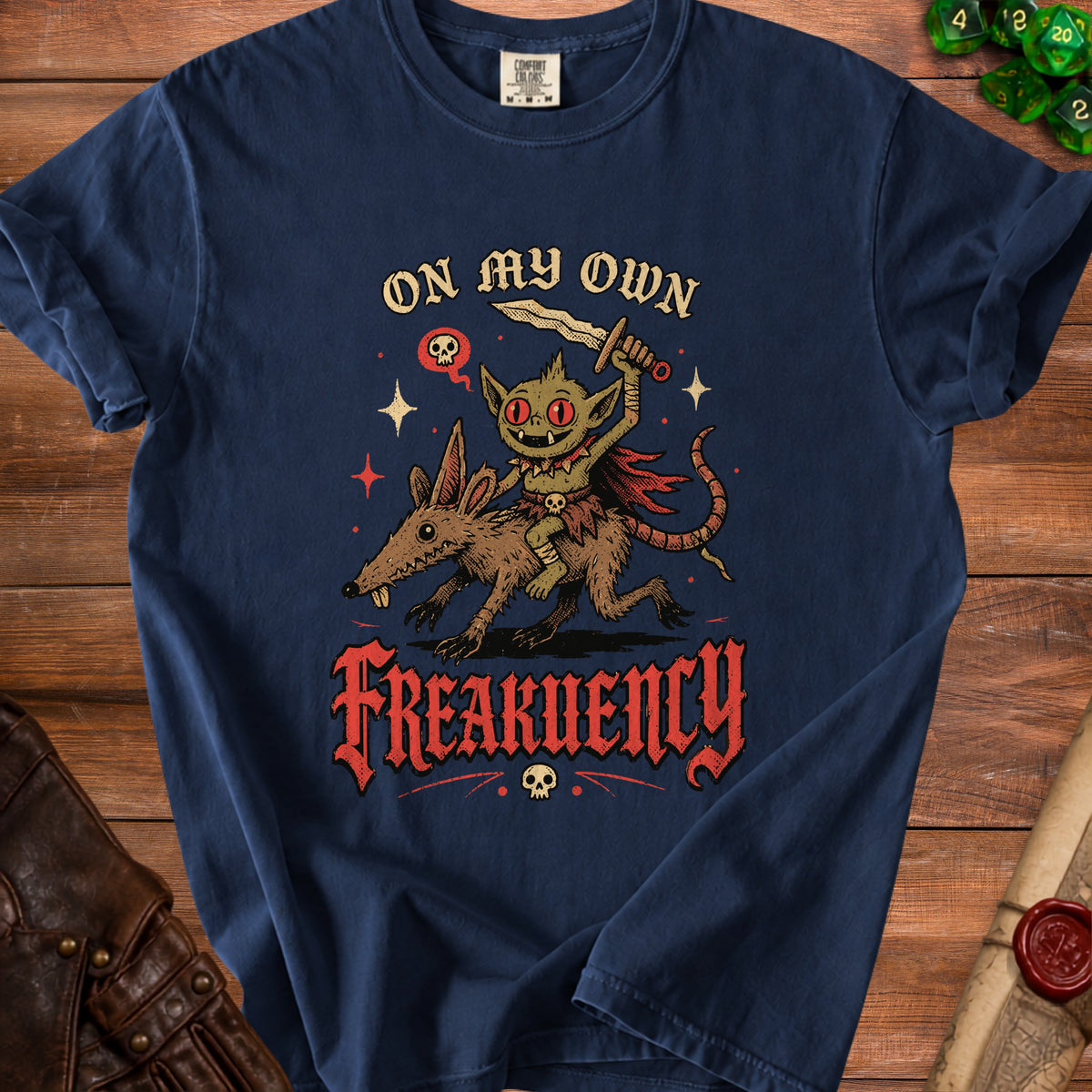 Goblin riding a rat with sword, text "ON MY OWN FREAKUENCY" and skull accents.