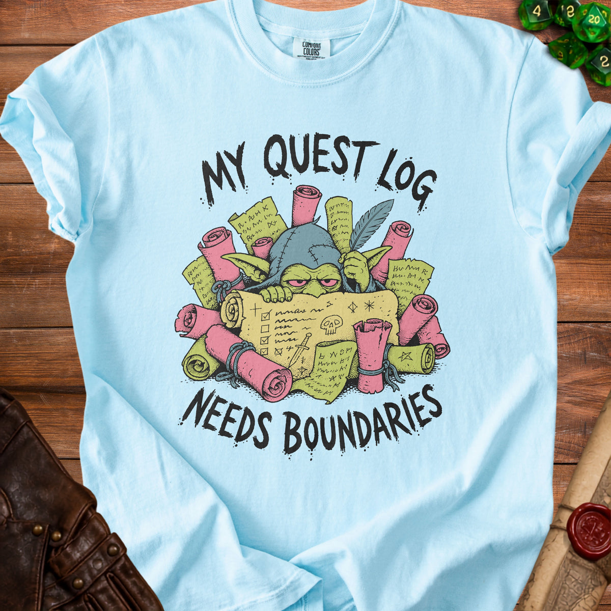 Light blue t-shirt with goblin illustration and text "My Quest Log Needs Boundaries."