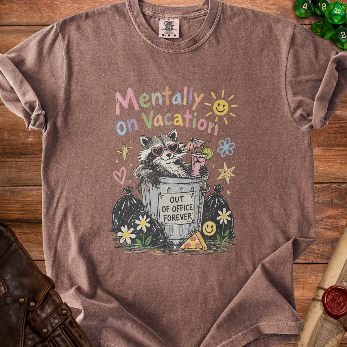 T-shirt graphic of raccoon in trash can with "Out of Office Forever" sign.