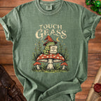 Green t-shirt with wizard frog on mushroom graphic saying "Touch Grass But Make It Magical".