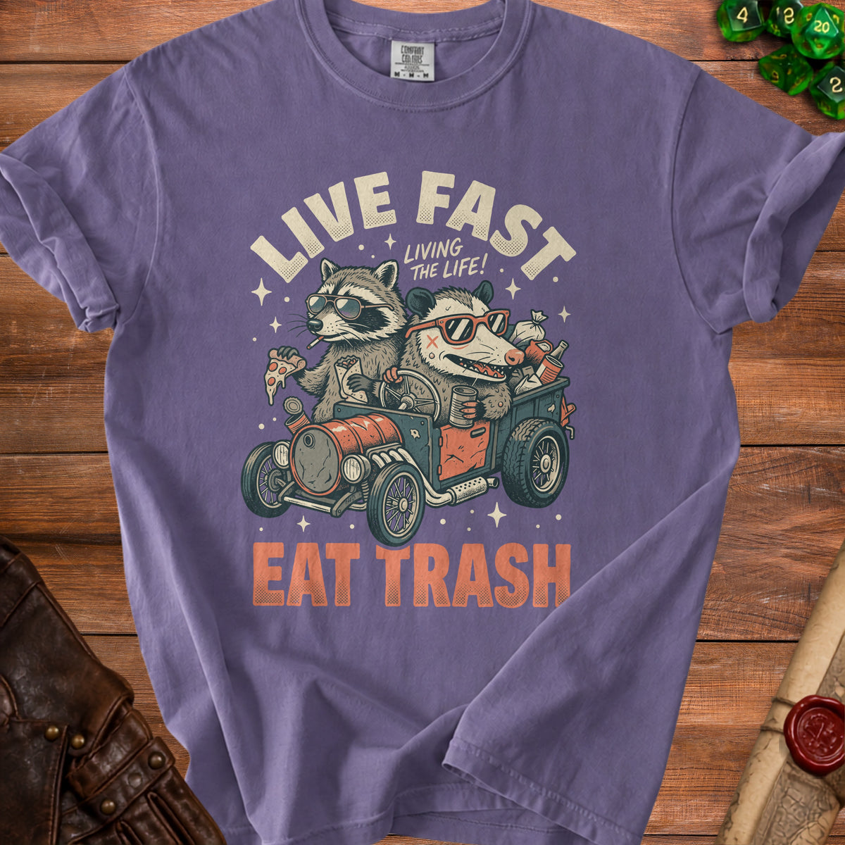 T-shirt with raccoons and opossums in a car, "Live Fast Eat Trash" text.