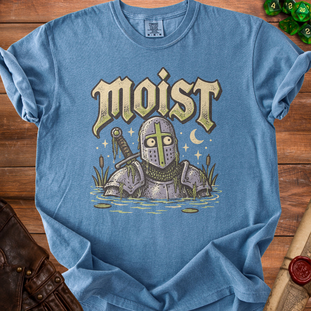Blue t-shirt with a knight in armor in water and the word "moist."