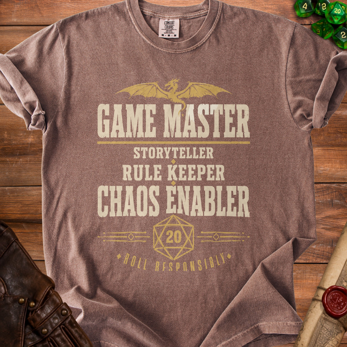 Brown t-shirt with text "Game Master", "Storyteller", "Rule Keeper", "Chaos Enabler", and "Roll Responsibly".