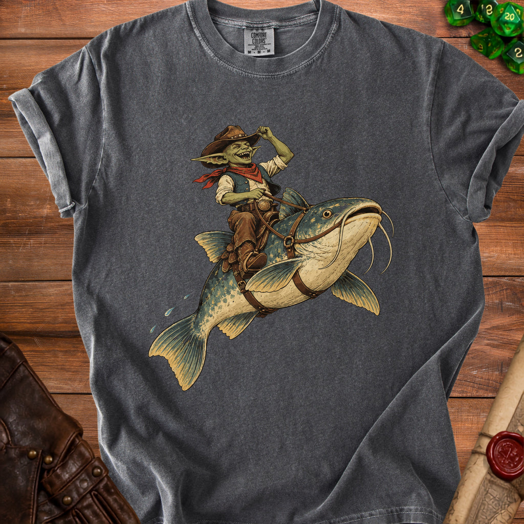 Goblin cowboy riding a catfish on a grey t-shirt.