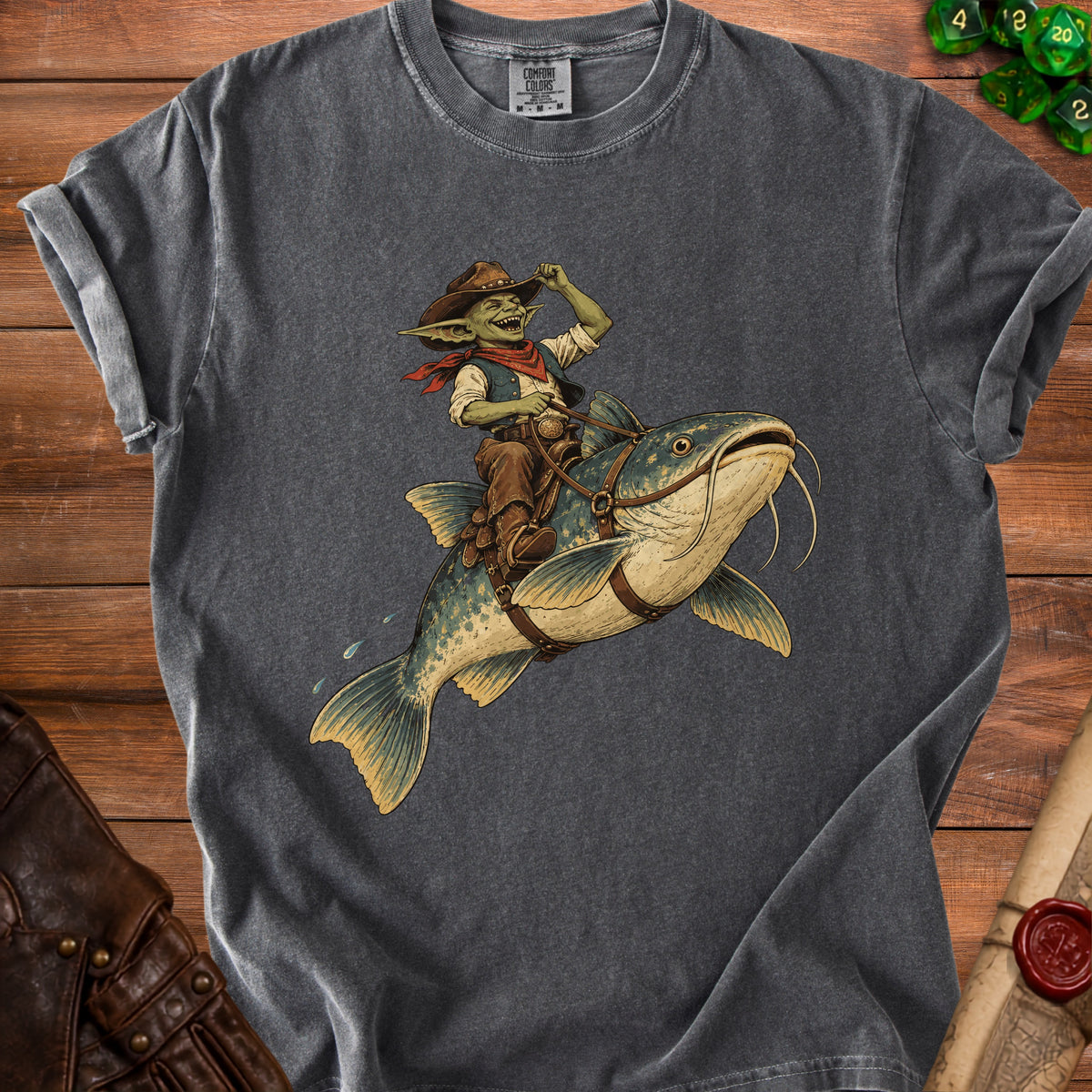 Goblin cowboy riding a catfish on a grey t-shirt.