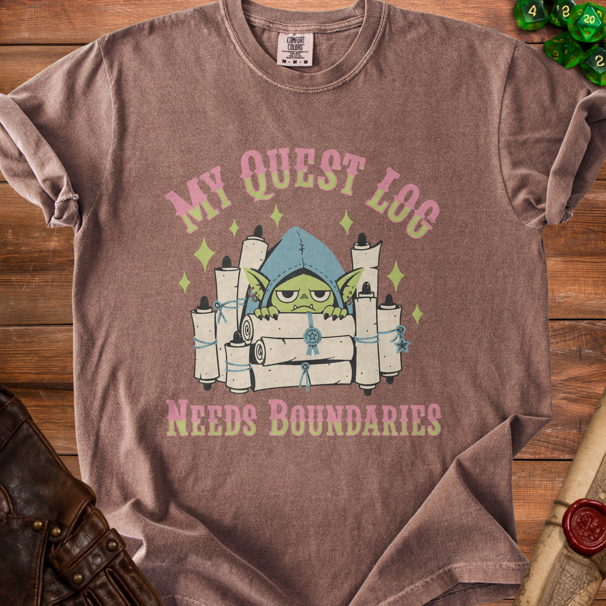 T-shirt with a goblin character surrounded by scrolls and the text "MY QUEST LOG NEEDS BOUNDARIES".