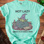 Green t-shirt with a wizard character wrapped in blankets and the text "NOT LAZY ENERGY IS IN HUDDLE MODE".