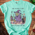 Mint green t-shirt with a witch, black cat, and books, reading "The older I get, the f*cker the no."