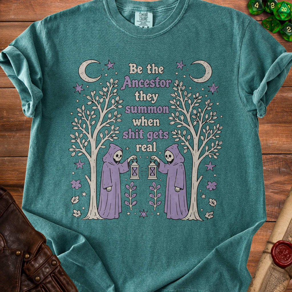 Teal t-shirt with "Be the ancestor they summon when shit gets real" text and grim reaper graphics.