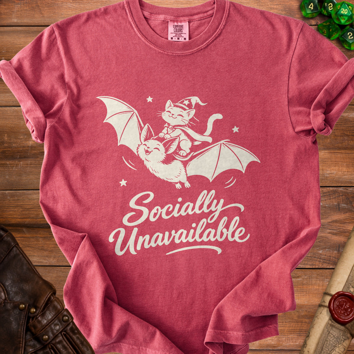 Pink t-shirt with graphic of cat on bat and text "Socially Unavailable".