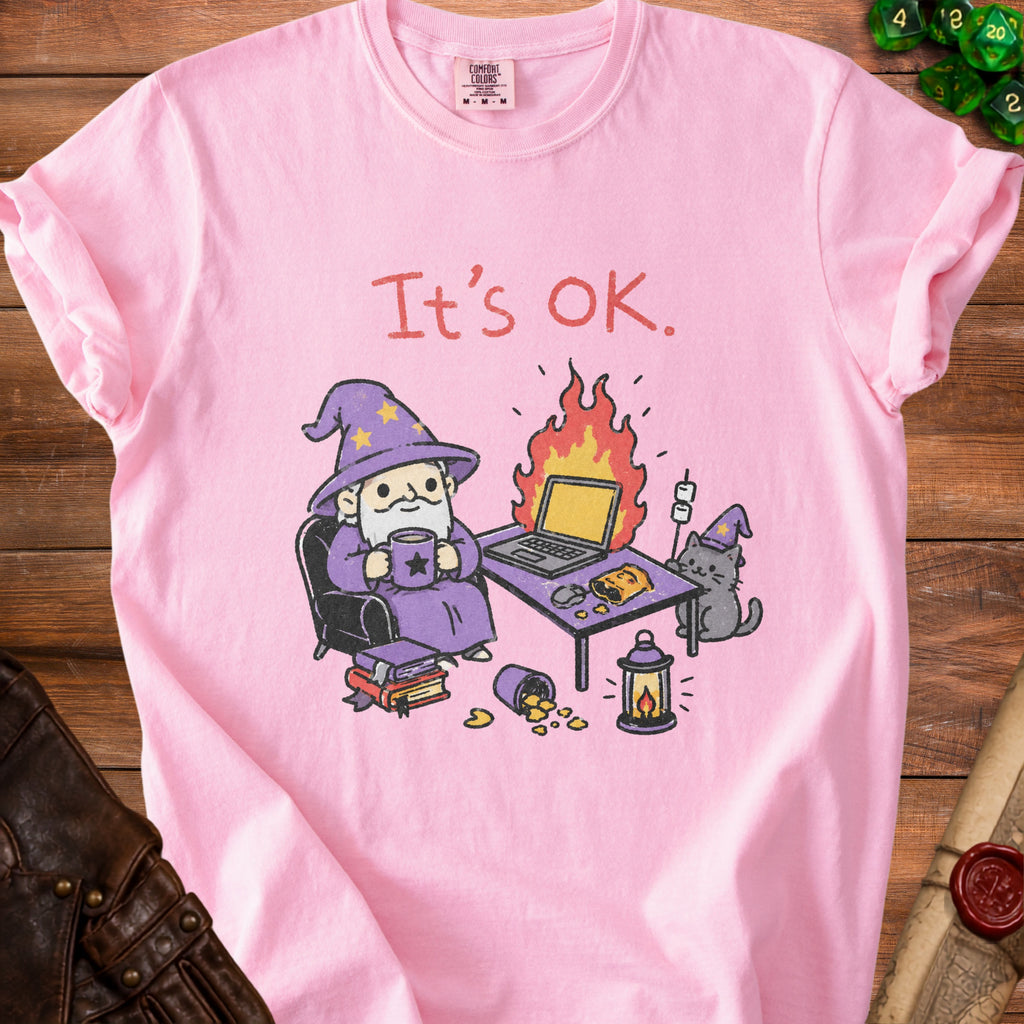 Pink t-shirt with illustration of wizard and cat at a desk with burning laptop.
