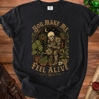 Skeleton knight watering plants under a crescent moon, text "You Make Me Feel Alive".