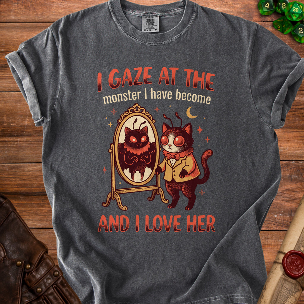 Dark grey t-shirt with graphic of cat looking in mirror and text "I GAZE AT THE monster I have become AND I LOVE HER".