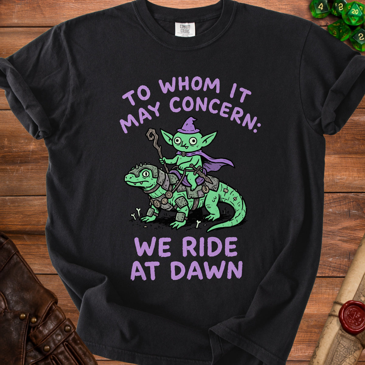 Black t-shirt with cartoon goblin riding a dragon, text says "To Whom It May Concern: We Ride At Dawn".