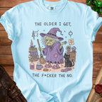 Light blue t-shirt with illustration of a witch and cat, reads "The older I get, the f*cker the no."
