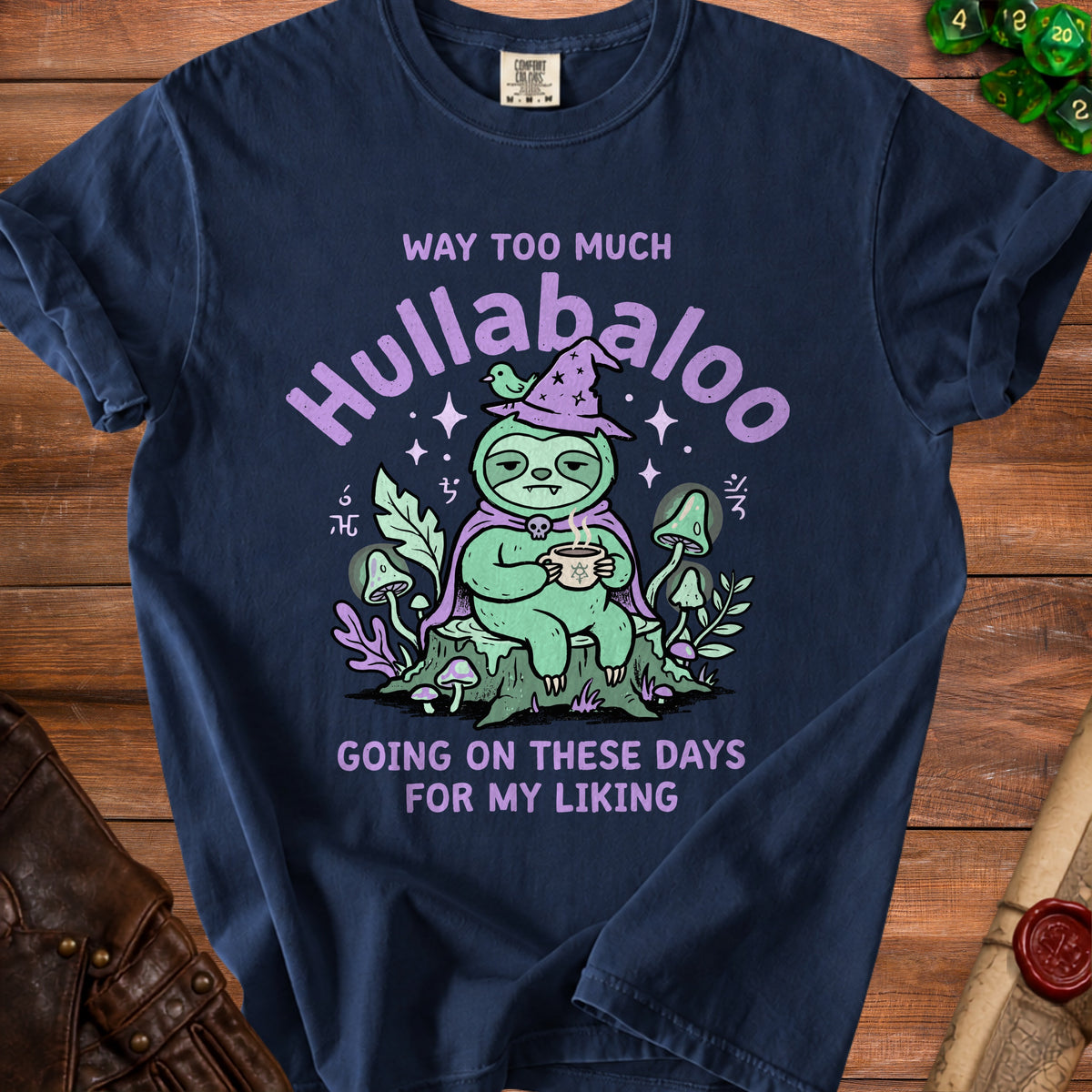 Navy t-shirt with a sloth wearing a witch hat and saying "Way too much hullabaloo going on these days for my liking".