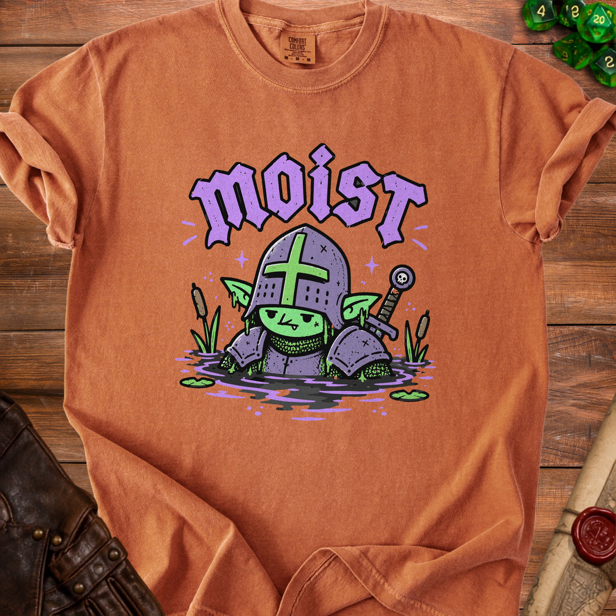 T-shirt with a cartoon goblin in armor in water, text "moist" above