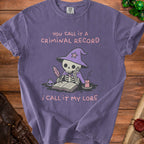 Purple t-shirt with skeleton wizard writing, "You call it a criminal record, I call it my lore."